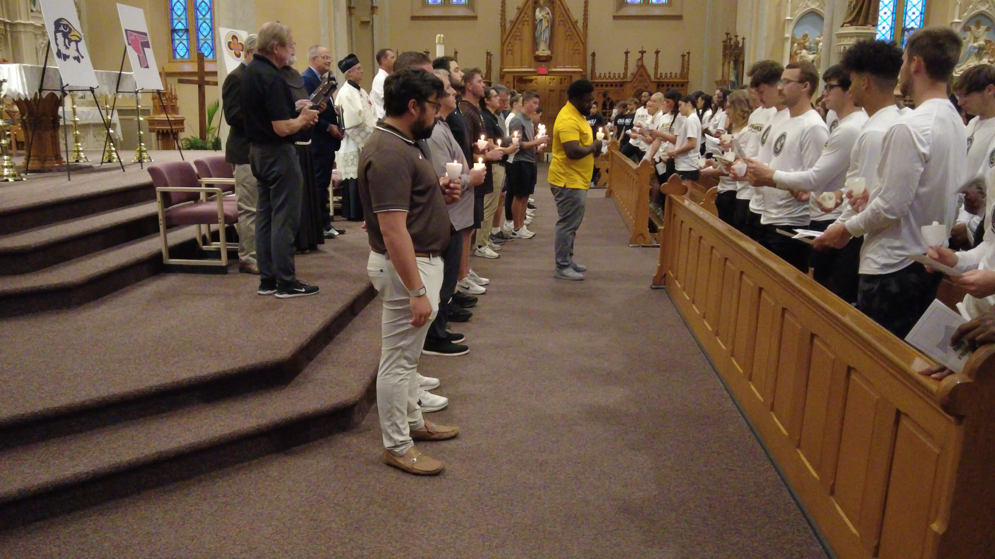 This is a picture of people lighting candles in a church